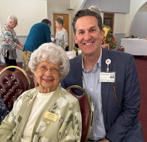 Shirley Dittus sitting with LMH president Dolan Dalpos
