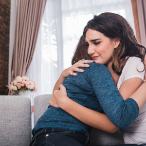 A person hugging another person