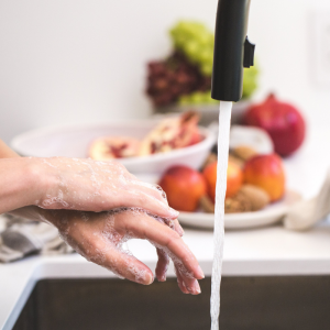 person washing hand in sink
